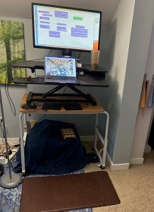 A standing desk with a mind map on the computer screen