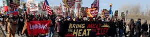 Activists hold signs and march to the Whipple Federal Building in Minneapolis